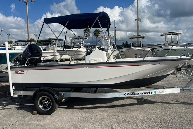 Slide: The Image of 2022 Boston Whaler 170 Montauk boat on EZ Loader trailer, parked outdoors. - 1