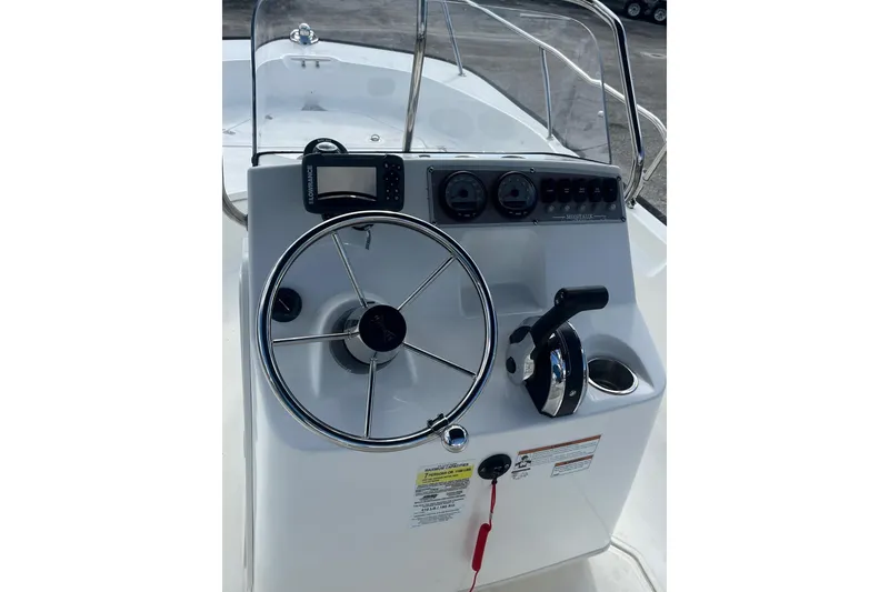 Slide: The Image of 2022 Boston Whaler 170 Montauk boat console with steering wheel and controls. - 11