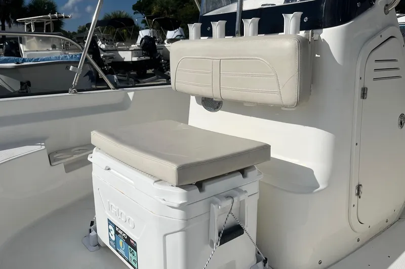 Slide: The Image of 2022 Boston Whaler 170 Montauk interior with cushioned seating and Igloo cooler. - 8