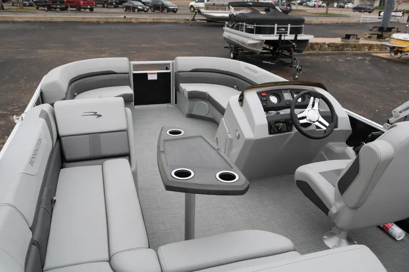 Slide: The Image of 2026 Bennington 20SXSNP REAR FISH pontoon boat interior with modern seating and steering console. - 11