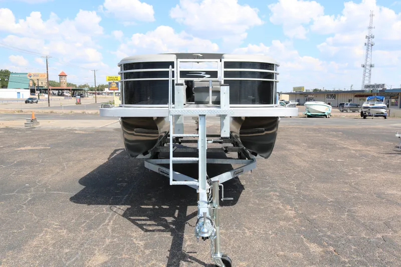 Slide: The Image of 2026 Bennington 20SXSNP REAR FISH pontoon boat on trailer, outdoor display. - 2