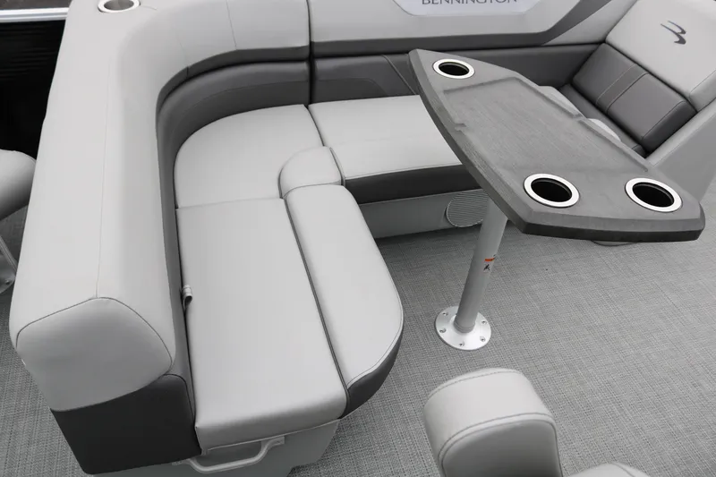 Slide: The Image of 2026 Bennington 20SXSNP REAR FISH boat interior with gray seating and table. - 26