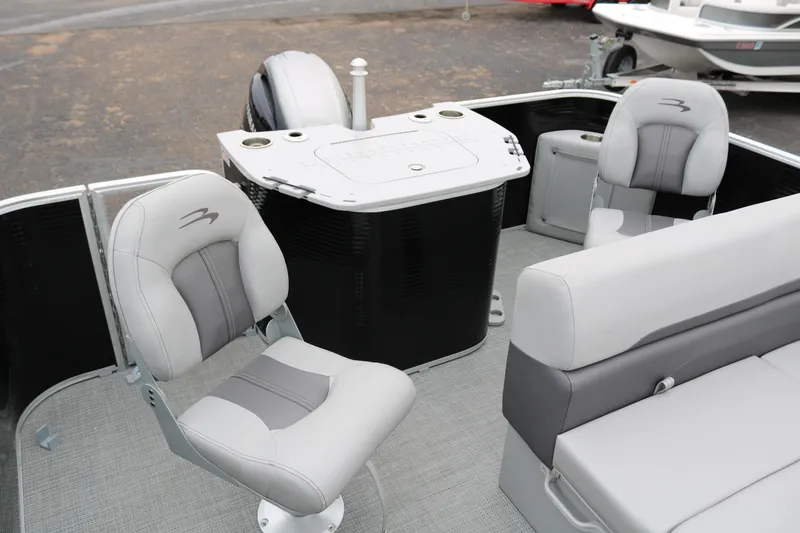 Slide: The Image of 2026 Bennington 20SXSNP REAR FISH boat interior with gray seating and table with cup holders. - 28