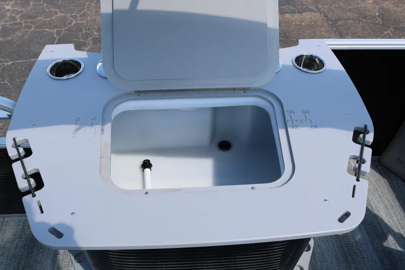 Slide: The Image of Open storage compartment on 2026 Bennington 20SXSNP REAR FISH boat with cup holders. - 32