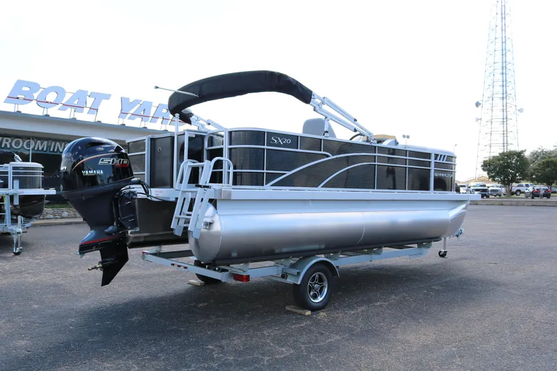 Slide: The Image of 2026 Bennington 20SXSNP Rear Fish pontoon boat on trailer at dealership. - 7