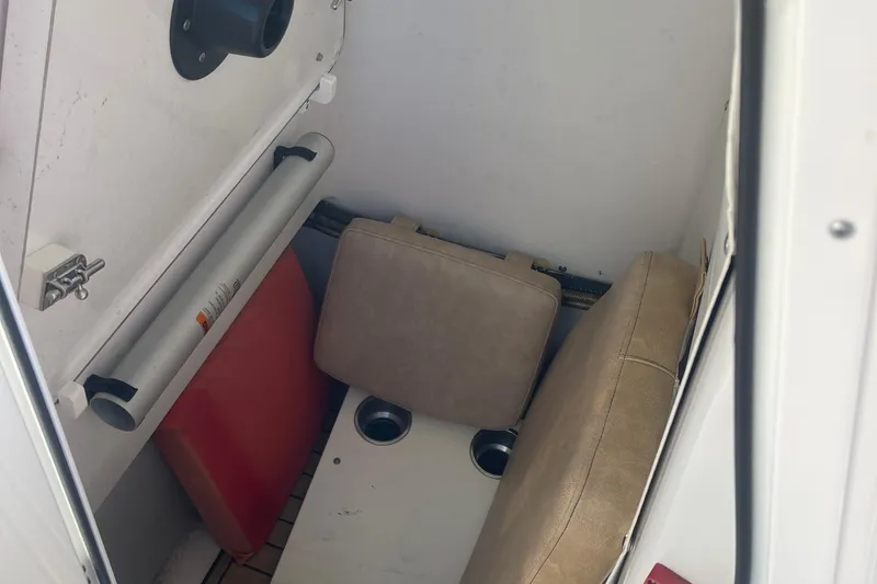 Slide: The Image of Interior storage of 2019 Sportsman Open 242 Center Console boat with cushions and accessories. - 11