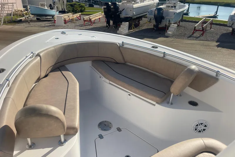 Slide: The Image of 2019 Sportsman Open 242 Center Console boat with beige seating and spacious deck. - 13