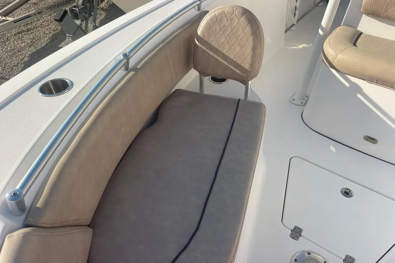 Slide: The Image of 2019 Sportsman Open 242 Center Console boat interior with cushioned seating and stainless steel rail. - 14