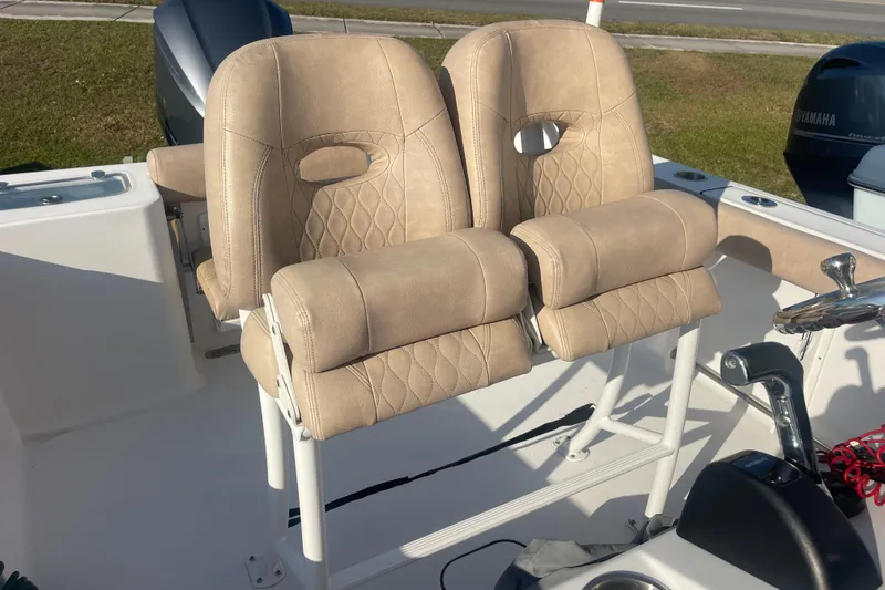Slide: The Image of 2019 Sportsman Open 242 Center Console boat seats with beige upholstery. - 22