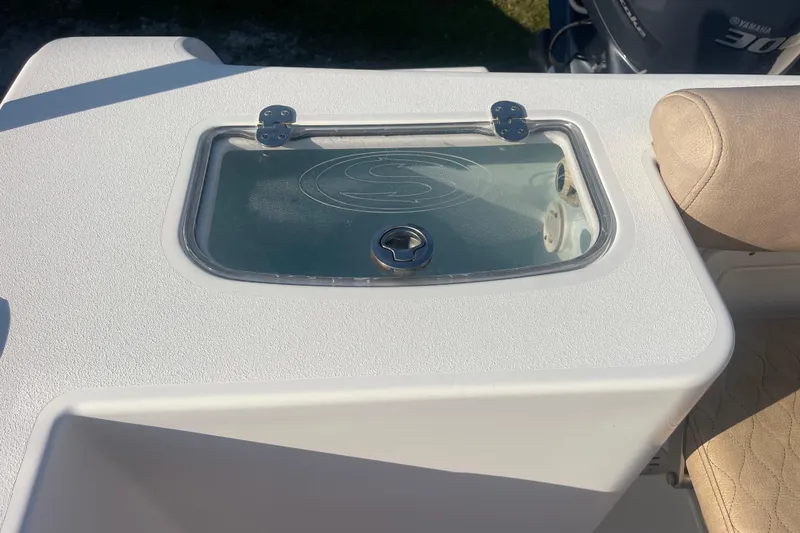 Slide: The Image of 2019 Sportsman Open 242 Center Console livewell with transparent lid and beige seating. - 25
