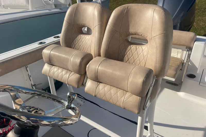 Slide: The Image of 2019 Sportsman Open 242 Center Console boat seats and steering wheel. - 27