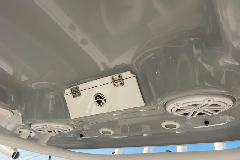 Slide: The Image of 2019 Sportsman Open 242 Center Console boat speakers and storage compartment. - 28