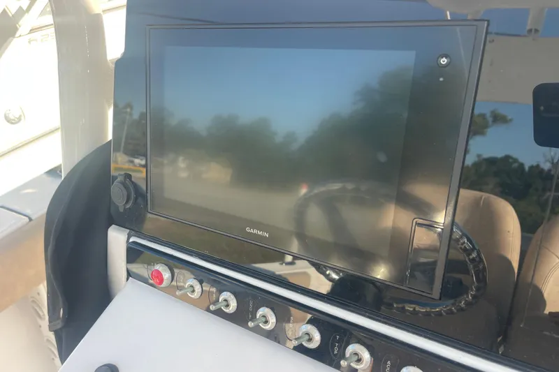 Slide: The Image of 2019 Sportsman Open 242 Center Console with Garmin display and control panel. - 31