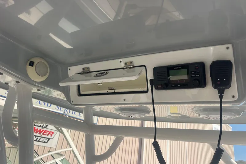 Slide: The Image of 2019 Sportsman Open 242 Center Console with Garmin radio and storage compartment. - 32