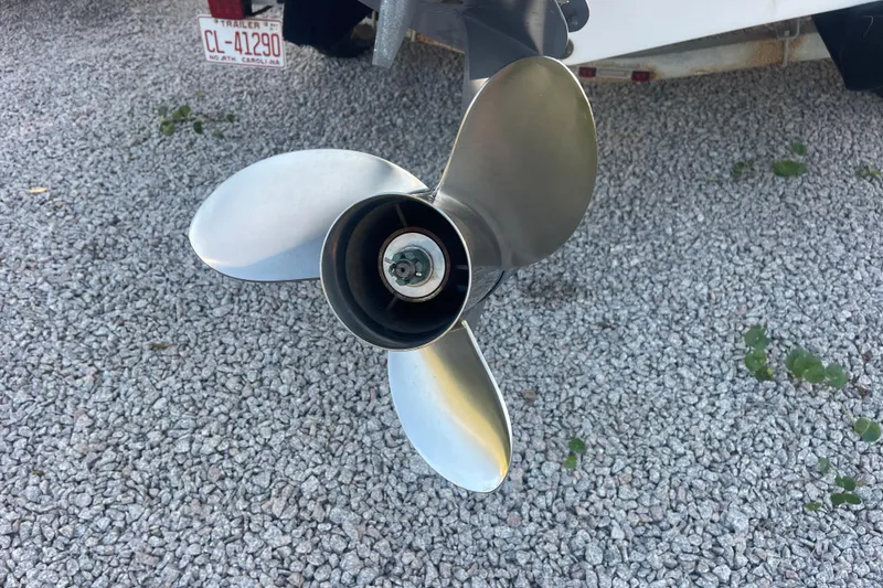 Slide: The Image of Propeller of a 2019 Sportsman Open 242 Center Console on gravel surface. - 44