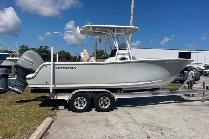 Slide: The Image of 2019 Sportsman Open 242 Center Console boat on trailer, parked outdoors. - 9