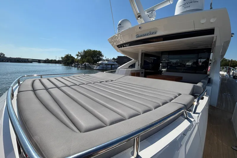 Slide: The Image of 2018 Sunseeker Predator 74 yacht with spacious sunbed and sleek design on a sunny day. - 13