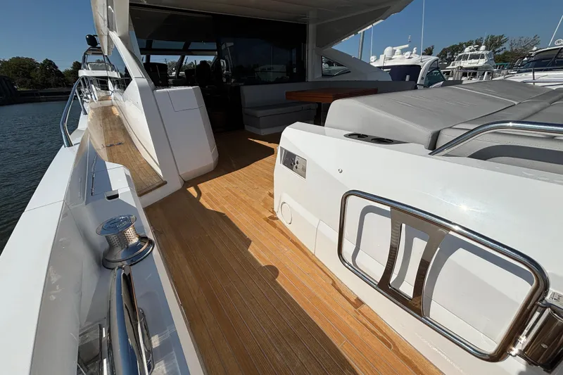 Slide: The Image of 2018 Sunseeker Predator 74 yacht deck with sleek design and luxurious seating. - 15