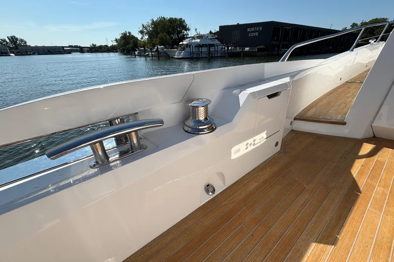 Slide: The Image of 2018 Sunseeker Predator 74 yacht deck with sleek railing and waterfront view. - 16