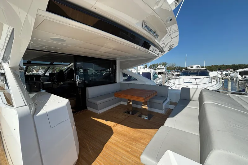 Slide: The Image of 2018 Sunseeker Predator 74 yacht with spacious outdoor seating and wooden deck. - 18