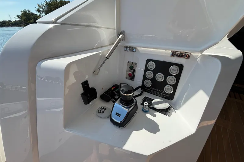 Slide: The Image of Control panel of 2018 Sunseeker Predator 74 yacht, featuring joystick and buttons. - 21