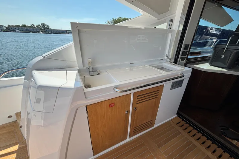 Slide: The Image of Outdoor kitchenette on 2018 Sunseeker Predator 74 yacht, featuring sink and storage cabinets. - 22