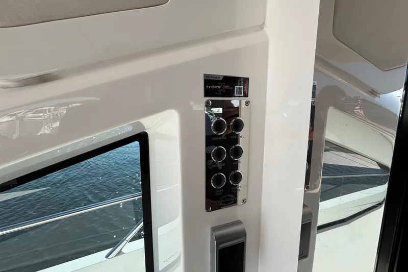 Slide: The Image of Control panel on 2018 Sunseeker Predator 74 yacht, featuring various switches and buttons. - 24