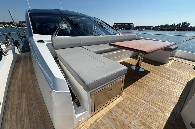 Slide: The Image of 2018 Sunseeker Predator 74 yacht with sleek deck seating and wooden table. - 29