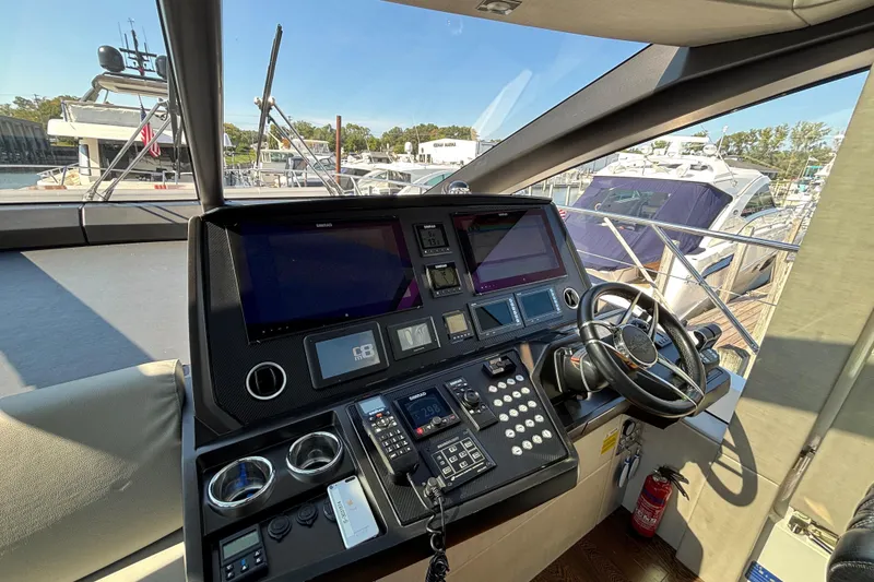 Slide: The Image of Helm of 2018 Sunseeker Predator 74 yacht with modern navigation equipment and steering wheel. - 39