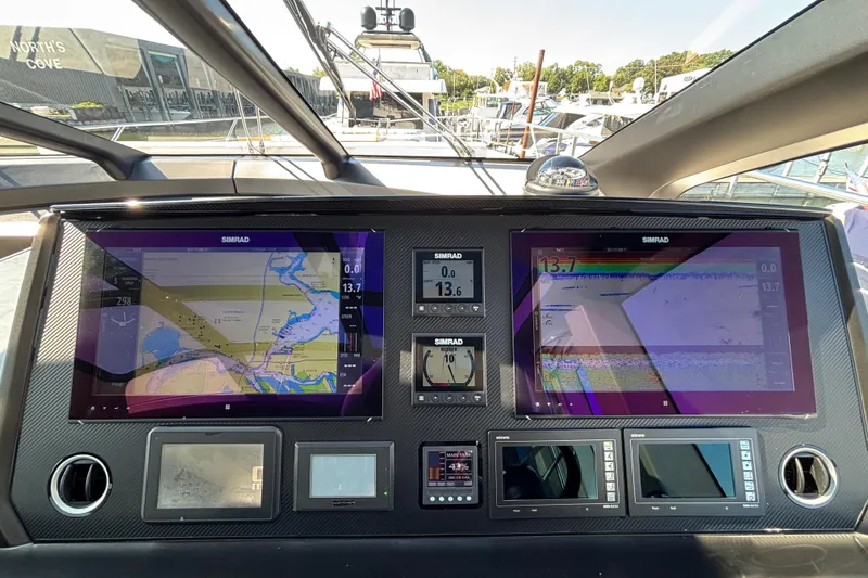Slide: The Image of 2018 Sunseeker Predator 74 yacht dashboard with navigation screens and controls. - 40