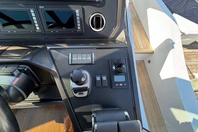 Slide: The Image of Control panel of a 2018 Sunseeker Predator 74 yacht, featuring modern navigation displays. - 42