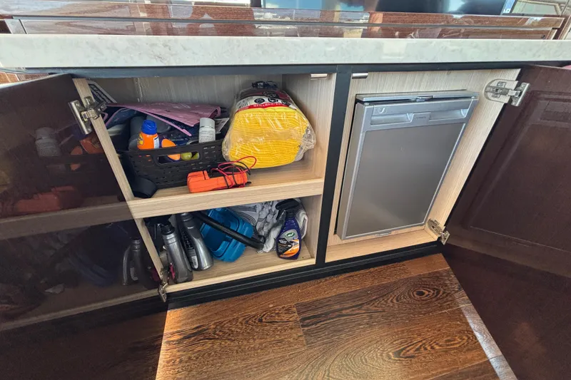 Slide: The Image of Open cabinet on Sunseeker Predator 74 yacht, showcasing storage and supplies. - 51