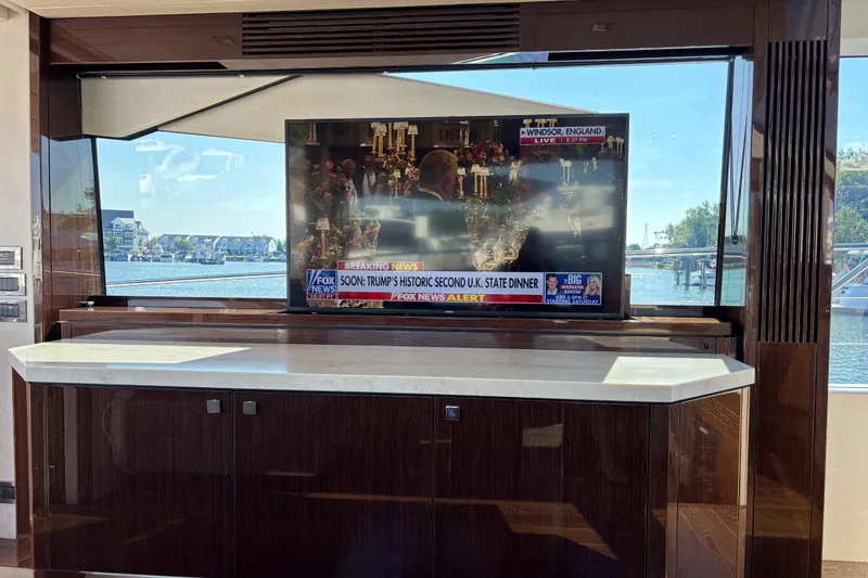 Slide: The Image of Interior of 2018 Sunseeker Predator 74 yacht with TV and waterfront view. - 56