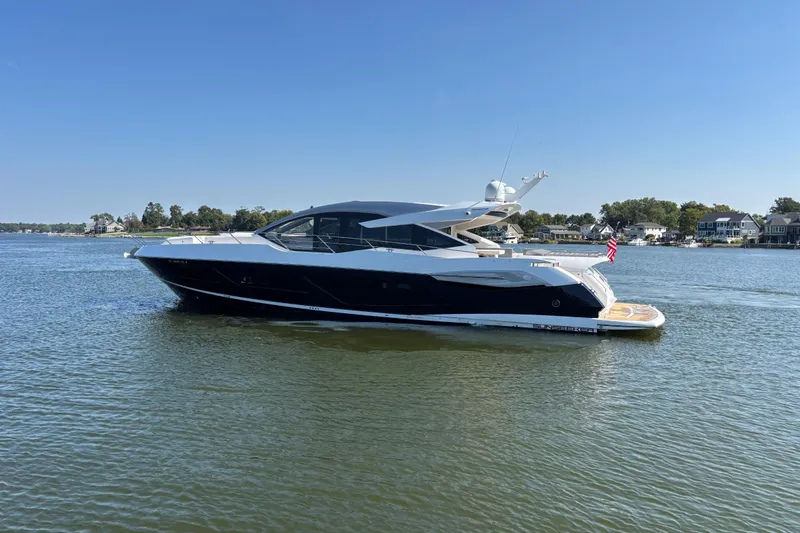 Slide: The Image of 2018 Sunseeker Predator 74 yacht on calm water under clear blue sky. - 8
