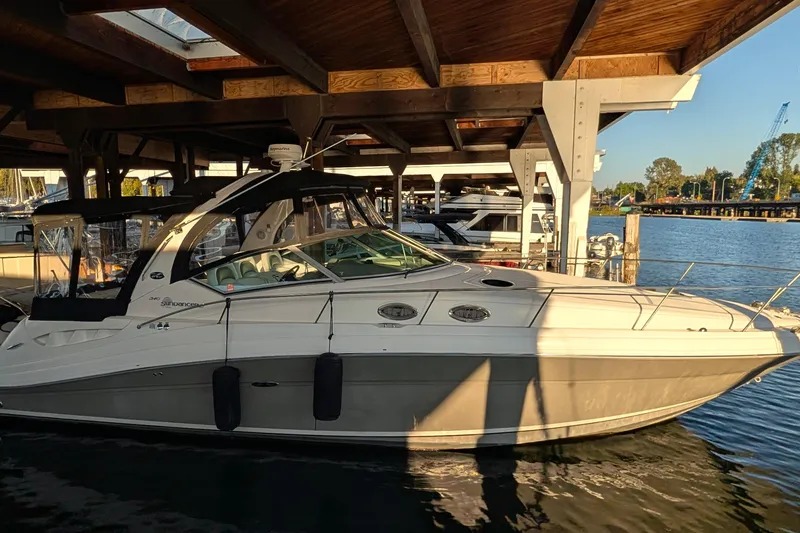 The Image of 2006 Sea Ray 340 Sundancer yacht on calm water near a bridge. - 0