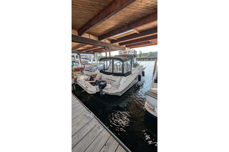 Slide: The Image of 2006 Sea Ray 340 Sundancer interior with open mini fridge and sleek design. - 13