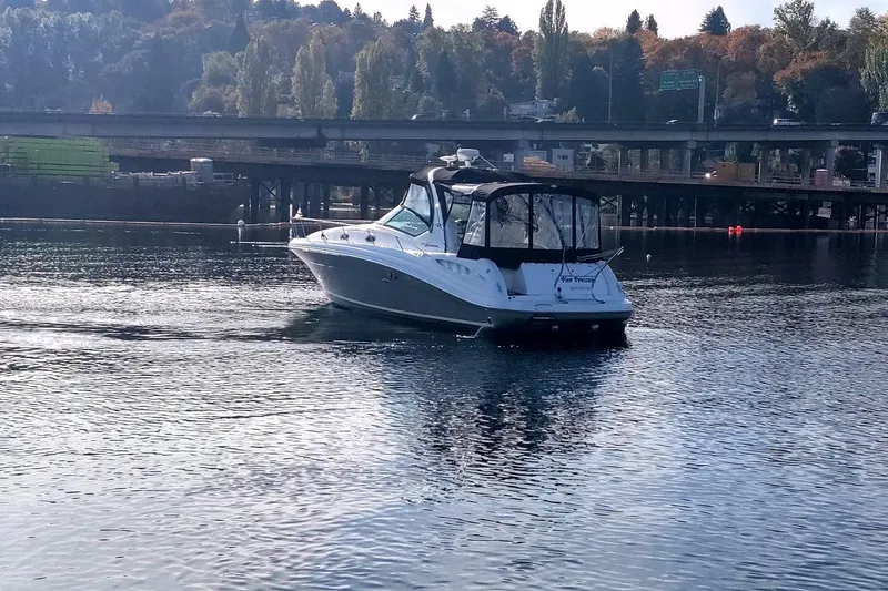 Slide: The Image of 2006 Sea Ray 340 Sundancer cruising on a calm river near a bridge. - 18
