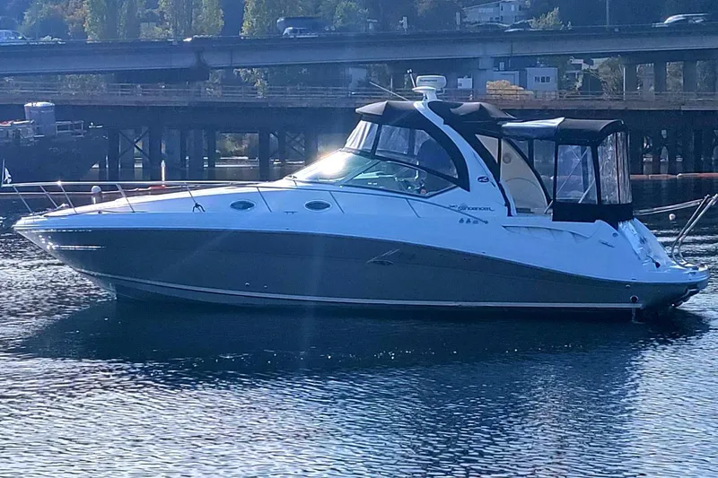 Slide: The Image of 2006 Sea Ray 340 Sundancer yacht on calm water near a bridge. - 21