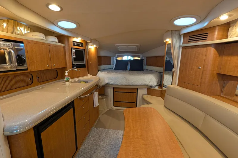 Slide: The Image of 2006 Sea Ray 340 Sundancer helm with Garmin navigation, overlooking serene waters. - 4