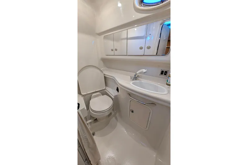 Slide: The Image of 2006 Sea Ray 340 Sundancer interior bathroom with open door and visible staircase. - 9