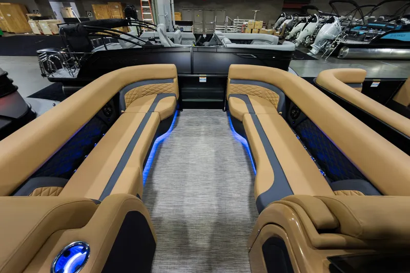 Slide: The Image of 2026 Godfrey Monaco 255 boat interior with luxurious tan seating and ambient blue lighting. - 31