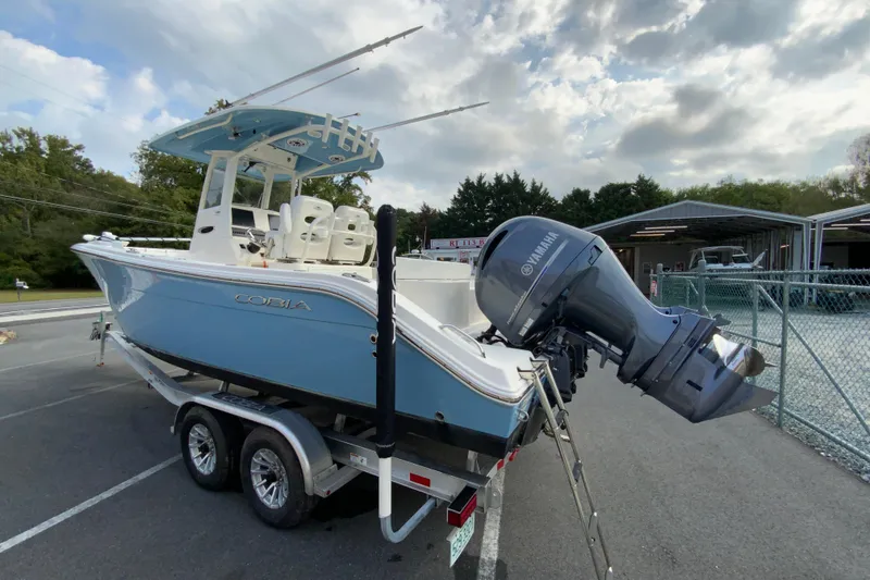 Slide: The Image of 2023 Cobia 262 Center Console boat on trailer with Yamaha outboard motor. - 13
