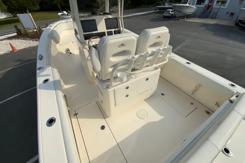Slide: The Image of 2023 Cobia 262 Center Console boat interior with dual seats and rod holders. - 18