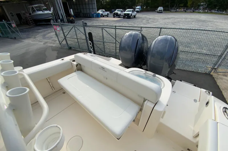 Slide: The Image of 2023 Cobia 262 Center Console boat with dual engines and seating area. - 21