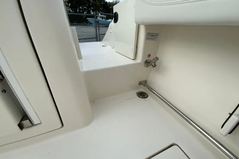 Slide: The Image of 2023 Cobia 262 Center Console interior detail with drain and faucet. - 22