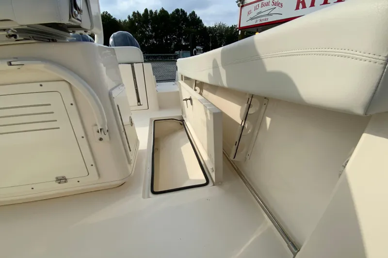 Slide: The Image of 2023 Cobia 262 Center Console boat interior with storage compartments and seating. - 24