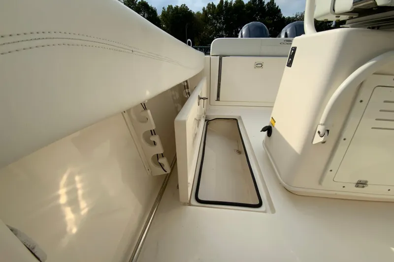 Slide: The Image of 2023 Cobia 262 Center Console boat interior with storage compartments and seating. - 27