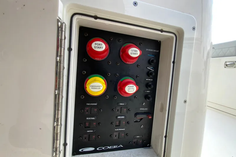 Slide: The Image of Control panel of 2023 Cobia 262 Center Console boat with start and emergency buttons. - 34