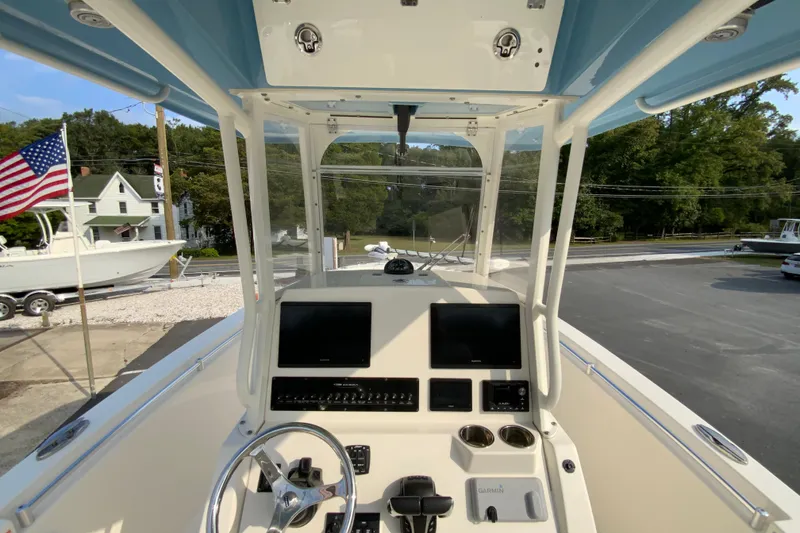 Slide: The Image of 2023 Cobia 262 Center Console boat dashboard with dual screens and steering wheel. - 37