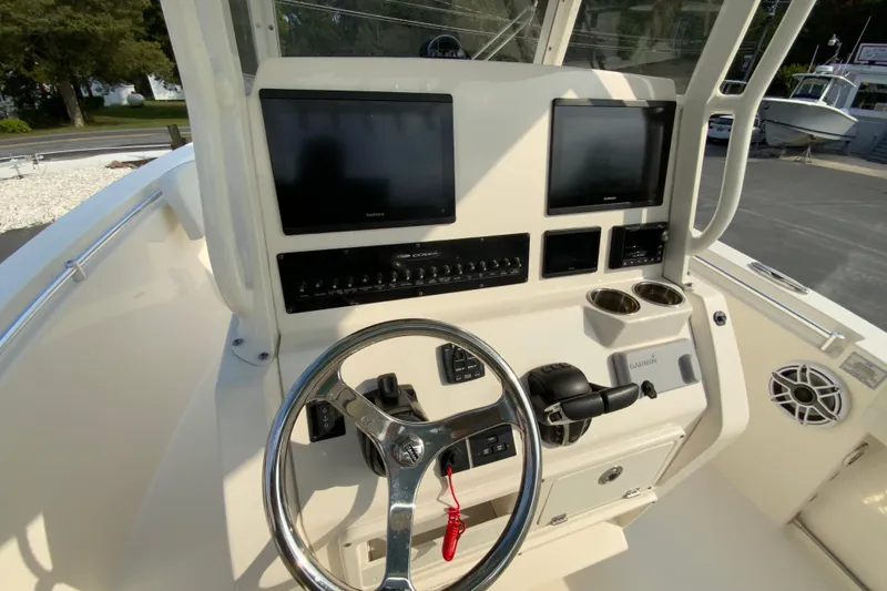 Slide: The Image of 2023 Cobia 262 Center Console helm with dual Garmin displays and steering wheel. - 39